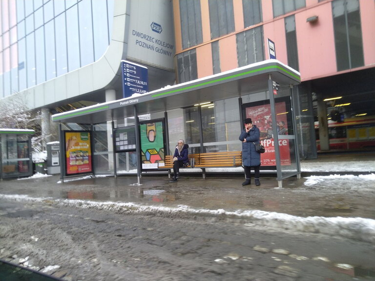 Bus stop at Poznań Główny station in winter with waiting passengers. Bus stop at Poznań Główny station in winter with waiting passengers.